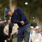 
              Tiger Woods hits from the fairway rough on the 13th hole during the first round of the Genesis Invitational golf tournament at Riviera Country Club, Thursday, Feb. 16, 2023, in the Pacific Palisades area of Los Angeles. (AP Photo/Ryan Kang)
            