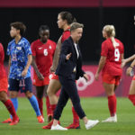 
              FILE - Canada coach Bev Priestman greets her players after they tied with Japan during a women's soccer match at the 2020 Summer Olympics on July 21, 2021, in Sapporo, Japan. Priestman says the dispute between her players and the Canadian federation is weighing on the team as it prepares for Thursday's opening match of the SheBelieves Cup against the United States. (AP Photo/Silvia Izquierdo, File)
            