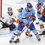 
              Montreal Canadiens' Kirby Dach (77) scores against New York Islanders goaltender Semyon Varlamov during the third period of an NHL hockey game in Montreal, Saturday, Feb. 11, 2023. (Graham Hughes/The Canadian Press via AP)
            