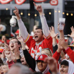 
              Kansas City Chiefs fans react as they gather before a Super Bowl 57 NFL football game watch party in the Power and Light entertainment district in Kansas City, Mo., Sunday, Feb. 12, 2023. (AP Photo/Colin E. Braley)
            