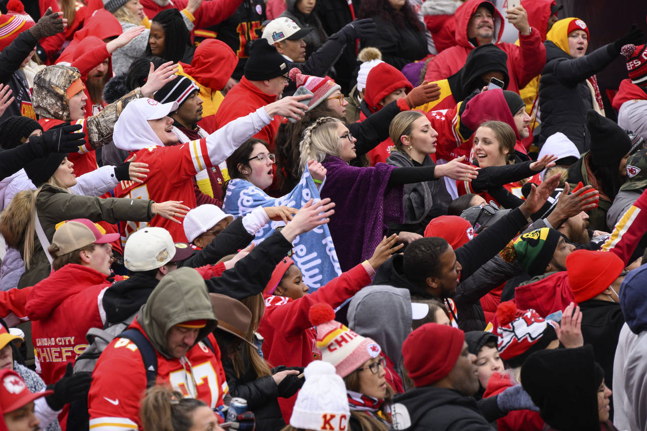 Fans do the tomahawk chop during the Kansas City Chiefs' victory celebration and parade in Kansas C...