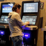 
              A man checks the odds on a sports betting terminal at the Ocean Casino Resort in Atlantic City, N.J., Monday, Feb. 6, 2023. On Feb. 7, 2023, the gambling industry's national trade group, the American Gaming Association, predicted that over 50 million American adults will bet a total of $16 billion on this year's Super Bowl, including legal bets with sports books, illegal ones with bookies, and casual bets among friends or relatives. (AP Photo/Wayne Parry)
            