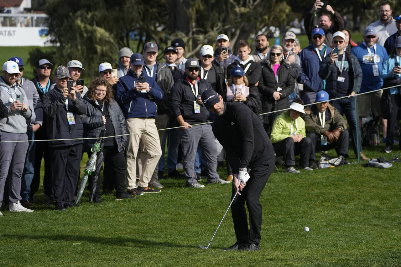 Aaron Rodgers follows his shot onto the 16th green of the Pebble Beach Golf Links during the third ...