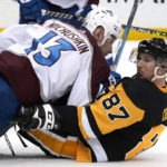 
              Colorado Avalanche's Valeri Nichushkin (13) falls on top of Pittsburgh Penguins' Sidney Crosby during the second period of an NHL hockey game in Pittsburgh, Tuesday, Feb. 7, 2023. (AP Photo/Gene J. Puskar)
            