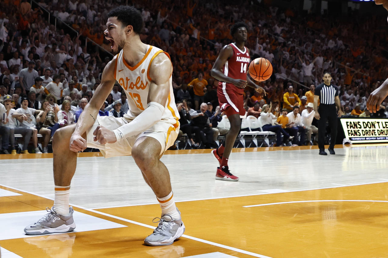 Tennessee forward Olivier Nkamhoua (13) reacts to dunking the ball during the first half of an NCAA...