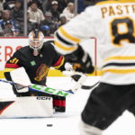
              Vancouver Canucks' goalie Arturs Silovs (31) stops the shot of Boston Bruins' David Pastrnak (88) during the second period of an NHL hockey game, Saturday, Feb. 25, 2023 in Vancouver, British Columbia. (Rich Lam/The Canadian Press via AP)
            