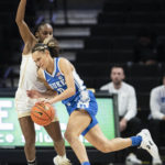 
              FILE -  Duke guard Celeste Taylor (0) pushes her way past Wake Forest guard Kaia Harrison, left, in the second half of an NCAA college basketball game Thursday, Jan. 5, 2023, in Winston-Salem, N.C. With Duke rising to No. 9 in this week's AP Top 25, it marks only the second time since 2000 that each of neighboring schools Duke, North Carolina and North Carolina State have cracked the top 10 in the same season. (Allison Lee Isley/The Winston-Salem Journal via AP, File)
            
