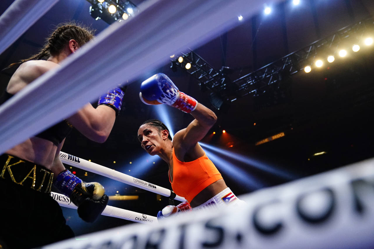 FILE - Amanda Serrano punches Ireland's Katie Taylor during the fourth round of a lightweight champ...