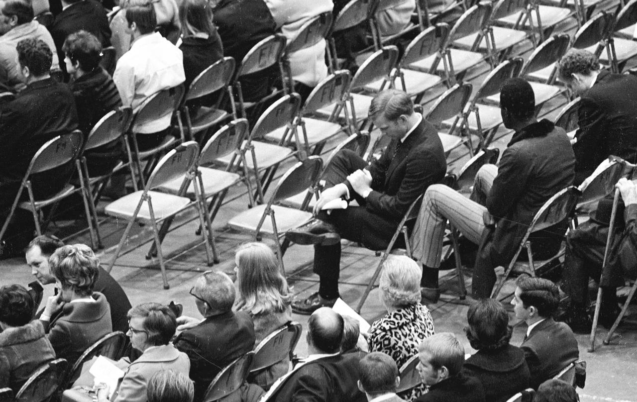 FILE - Marshall assistant football coach Red Dawson, center, sits alone during a memorial service a...