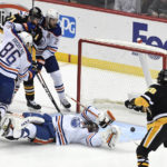 
              Pittsburgh Penguins defenseman Kris Letang (58) shoots and scores on Edmonton Oilers goalie Stuart Skinner (74) during the first period of an NHL hockey game, Thursday, Feb. 23, 2023, in Pittsburgh. (AP Photo/Philip G. Pavely)
            