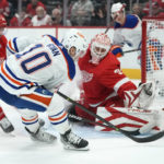 
              Detroit Red Wings goaltender Ville Husso (35) stops a Edmonton Oilers center Derek Ryan (10) shot as \Pius Suter (24) defends in the first period of an NHL hockey game Tuesday, Feb. 7, 2023, in Detroit. (AP Photo/Paul Sancya)
            