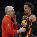 
              Atlanta Hawks interim head coach Joe Prunty, left, talks with guard Trae Young during the first half of an NBA basketball game against the Cleveland Cavaliers, Friday, Feb. 24, 2023, in Atlanta. (AP Photo/John Bazemore)
            