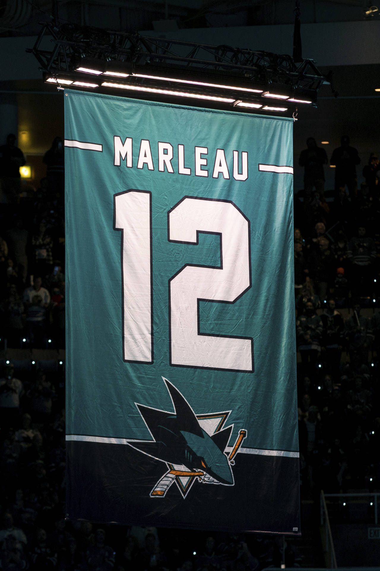 Former San Jose Sharks player Patrick Marleau's No. 12 hangs from the ceiling during the number ret...