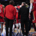
              New Orleans Pelicans forward Larry Nance Jr., center is helped off the court during the first half of the team's NBA basketball game against the New York Knicks, Saturday, Feb. 25, 2023, at Madison Square Garden in New York. (AP Photo/Mary Altaffer)
            