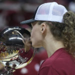 
              Indiana's Grace Berger kisses the trophy after her team defeated Purdue in an NCAA college basketball game, Sunday, Feb. 19, 2023, in Bloomington, Ind. (AP Photo/Darron Cummings)
            