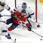 
              Florida Panthers center Sam Bennett (9) dives for the puck as the net is guarded by Tampa Bay Lightning goaltender Andrei Vasilevskiy (88) defenseman Zach Bogosian (24) and center Anthony Cirelli (71) during the second period of an NHL hockey game, Monday, Feb. 6, 2023, in Sunrise, Fla. (AP Photo/Wilfredo Lee)
            