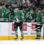 
              Dallas Stars' Jason Robertson (21) and Joe Pavelski (16) celebrate with the bench after Robertson scored in the second period of an NHL hockey game against the Boston Bruins, Tuesday, Feb. 14, 2023, in Dallas. (AP Photo/Tony Gutierrez)
            