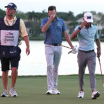 
              Chris Kirk, center, walks off the green after winning the Honda Classic golf tournament in a playoff against Eric Cole, right, Sunday, Feb. 26, 2023, in Palm Beach Gardens, Fla. Cole's caddie Reed Cole, left, also walks off the green. (AP Photo/Lynne Sladky)
            