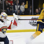 
              Nashville Predators center Philip Tomasino (26) tries to deflect the puck past Florida Panthers goaltender Spencer Knight (30) during the second period of an NHL hockey game Saturday, Feb.18, 2023, in Nashville, Tenn. (AP Photo/Mark Zaleski)
            