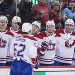 
              The Montreal Canadiens celebrate with Justin Barron (52) after Barron scored a goal during the first period of an NHL hockey game against the New Jersey Devils Tuesday, Feb. 21, 2023, in Newark, N.J. (AP Photo/Frank Franklin II)
            