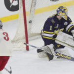 
              Ohio State's Cole McWard (3) puts a shot into the back of the net against Michigan goalie Erik Portillo for a score in the second period during the "Faceoff On The Lake" college hockey game Saturday, Feb. 18, 2023, in Cleveland. (John Kuntz/Cleveland.com via AP)
            