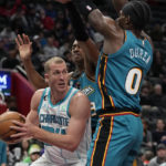 
              Charlotte Hornets center Mason Plumlee (24) looks to pass around Detroit Pistons center Jalen Duren (0) during the second half of an NBA basketball game, Friday, Feb. 3, 2023, in Detroit. (AP Photo/Carlos Osorio)
            