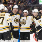 
              Boston Bruins' Brad Marchand, second from right, celebrates with teammates, from left, Hampus Lindholm, Brandon Carlo and Jake DeBrusk after scoring a goal against the Vancouver Canucks during the first period of an NHL hockey game, Saturday, Feb. 25, 2023 in Vancouver, British Columbia. (Rich Lam/The Canadian Press via AP)
            