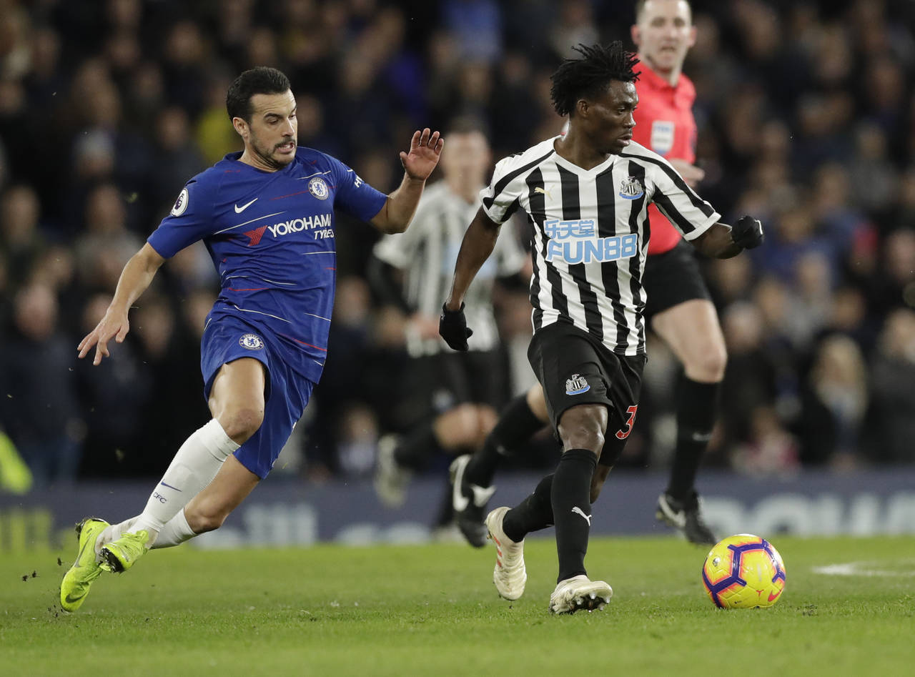 FILE - Chelsea's Pedro, left, and Newcastle United's Christian Atsu vie for the ball during the Eng...