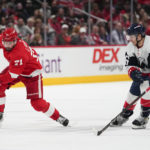 
              Detroit Red Wings center Dylan Larkin (71) skates with the puck against Washington Capitals center Nic Dowd (26) during the first period of an NHL hockey game, Tuesday, Feb. 21, 2023, in Washington. (AP Photo/Julio Cortez)
            