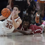 
              Texas forward Brock Cunningham (30) and Oklahoma guard Otega Oweh, right, scramble for the ball during overtime of an NCAA college basketball game in Austin, Texas, Saturday, Feb. 18, 2023. (AP Photo/Eric Gay)
            