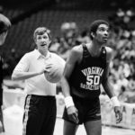 
              FILE - Virginia coach Terry Holland yells out instructions during NCAA college basketball practice in Philadelphia ahead of an NCAA Tournament game against North Carolina, Friday, March 28, 1981. At right is Virginia center Ralph Sampson. Terry Holland, who elevated Virginia basketball to national prominence during 16 seasons as coach and later had a distinguished career as an athletic administrator, has died, the school announced Monday. He was 80. (AP Photo/Gene Puskar, File)
            