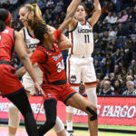 
              UConn's Lou Lopez-Senechal (11) makes a 3 point basket in the first half of an NCAA college basketball game against St. John's, Tuesday, Feb. 21, 2023, in Hartford, Conn. (AP Photo/Jessica Hill)
            