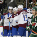 
              Colorado Avalanche's Nathan MacKinnon (29) is congratulated by Bowen Byram (4) and Valeri Nichushkin (13) after his second-period goal against the Minnesota Wild in an NHL hockey game Wednesday, Feb. 15, 2023, in St. Paul, Minn. (AP Photo/Andy Clayton-King)
            