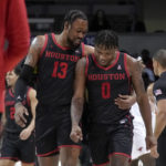 
              Houston forward J'Wan Roberts (13) and guard Marcus Sasser (0) celebrate after Sasser made a 3-point shot during the second half of the team's NCAA college basketball game against SMU, Thursday, Feb. 16, 2023, in Dallas. (AP Photo/Tony Gutierrez)
            