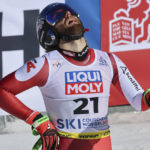 
              Austria's Marco Schwarz gets to the finish area after completing the alpine ski, men's World Championship downhill, in Courchevel, France, Sunday, Feb. 12, 2023. (AP Photo/Marco Trovati)
            