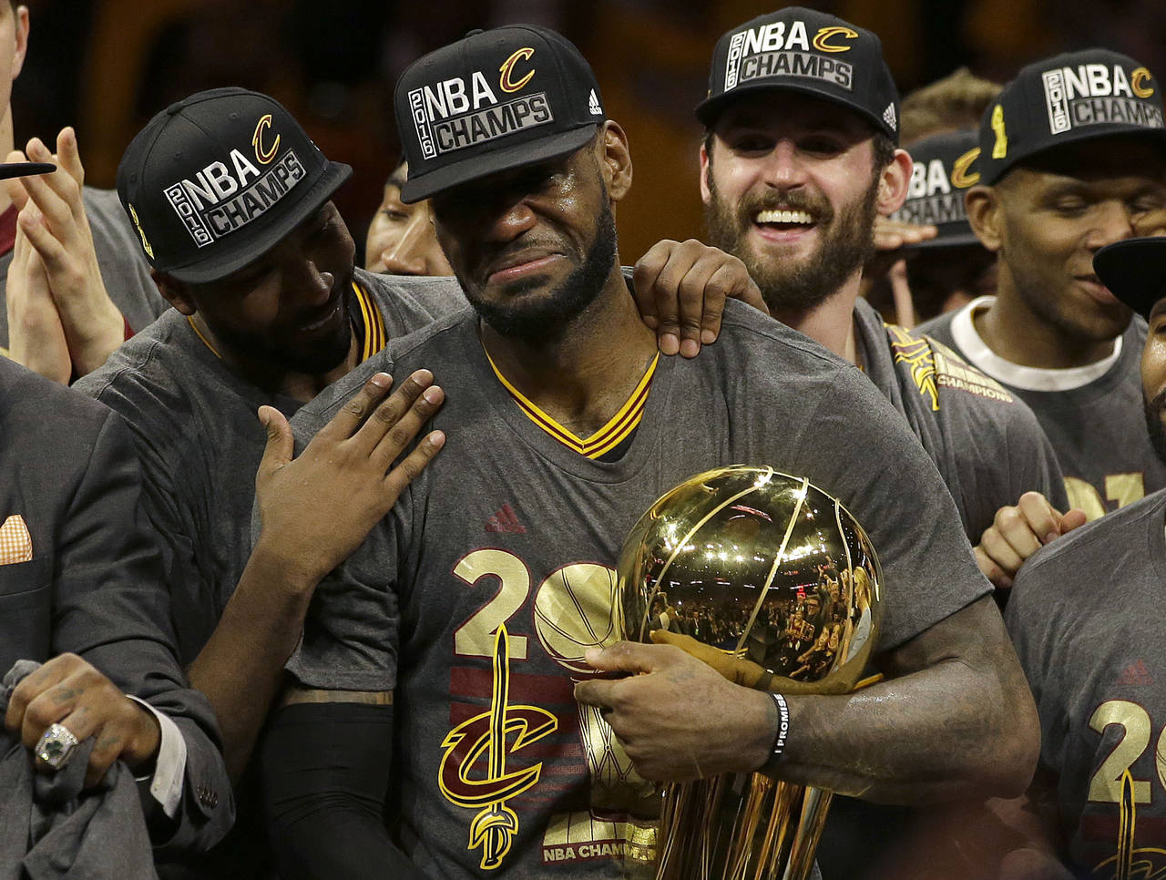 FILE -Cleveland Cavaliers forward LeBron James, center, celebrates with teammates after Game 7 of b...