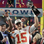 
              Kansas City Chiefs quarterback Patrick Mahomes (15) holds the Vince Lombardi Trophy next to Terry Bradshaw, left, and Chiefs owner Clark Hunt after the NFL Super Bowl 57 football game against the Philadelphia Eagles, Sunday, Feb. 12, 2023, in Glendale, Ariz. The Kansas City Chiefs defeated the Philadelphia Eagles 38-35. (AP Photo/Marcio J. Sanchez)
            