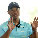 
              Golfer Tiger Woods gestures as he and Rory McIlroy discuss the future home of their tech-infused golf league that will begin play next year, Tuesday, Feb. 21, 2023, on the campus of Palm Beach State College in Palm Beach Gardens, Fla. (AP Photo/Wilfredo Lee)
            