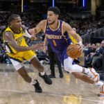 
              Phoenix Suns guard Devin Booker (1) drives against Indiana Pacers guard Bennedict Mathurin (00) during the second half of an NBA basketball game in Indianapolis, Friday, Feb. 10, 2023. (AP Photo/Doug McSchooler)
            