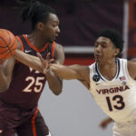 
              Virginia Tech's Justyn Mutts (25) has the ball tipped from him by Virginia's Ryan Dunn (13) i in the first half of an NCAA college basketball game in Blacksburg Va., Saturday, Feb. 4, 2023. (Matt Gentry/The Roanoke Times via AP)
            