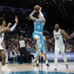 
              Charlotte Hornets guard LaMelo Ball (1) shoots during the first half of the team's NBA basketball game against the San Antonio Spurs on Wednesday, Feb. 15, 2023, in Charlotte, N.C. (AP Photo/Brian Westerholt)
            