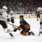 
              Anaheim Ducks' Trevor Zegras (11) is defended by Chicago Blackhawks' Connor Murphy (5) and Jason Dickinson (17) during the first period of an NHL hockey game Monday, Feb. 27, 2023, in Anaheim, Calif. (AP Photo/Jae C. Hong)
            