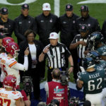
              Kansas City Chiefs and Philadelphia Eagles players stand at midfield for the coin toss prior to the NFL Super Bowl 57 football game, Sunday, Feb. 12, 2023, in Glendale, Ariz. (AP Photo/Charlie Riedel)
            