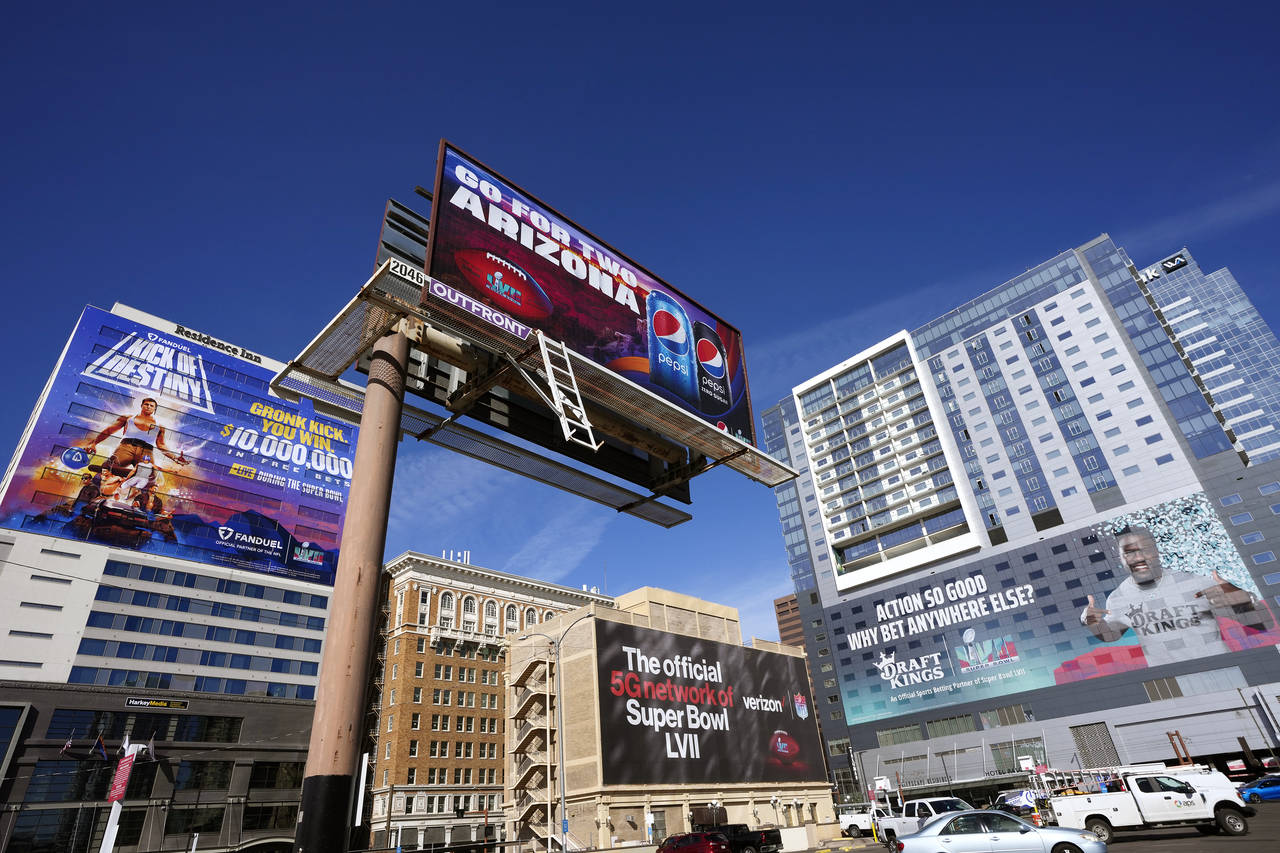 Large advertisements adorn buildings and electronic billboards leading up to the NFL Super Bowl LVI...