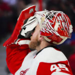 
              Detroit Red Wings goaltender Magnus Hellberg (45) wipes his face during a break in play while taking on the Ottawa Senators during second-period NHL hockey game action in Ottawa, Ontario, Monday, Feb. 27, 2023. (Sean Kilpatrick/The Canadian Press via AP)
            