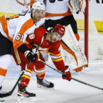 
              Philadelphia Flyers defenseman Justin Braun, left, checks Calgary Flames forward Andrew Mangiapane during second-period NHL hockey game action in Calgary, Alberta, Monday, Feb. 20, 2023. (Jeff McIntosh/The Canadian Press via AP)
            