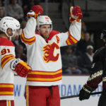 
              Calgary Flames center Elias Lindholm celebrates with center Nazem Kadri (91) after scoring against the Arizona Coyotes during the second period of an NHL hockey game Wednesday, Feb. 22, 2023, in Tempe, Ariz. (AP Photo/Rick Scuteri)
            