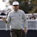 
              Keith Mitchell acknowledges the gallery on the 17th green during the second round of the Genesis Invitational golf tournament at Riviera Country Club, Friday, Feb. 17, 2023, in the Pacific Palisades area of Los Angeles. (AP Photo/Ryan Kang)
            