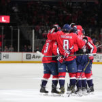 
              Washington Capitals players celebrate after a goal by Evgeny Kuznetsov during the third period of an NHL hockey game against the New York Rangers, Saturday, Feb. 25, 2023, in Washington. The Capitals won 6-3. (AP Photo/Julio Cortez)
            