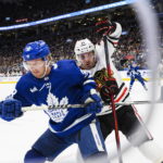 
              Toronto Maple Leafs defenseman Rasmus Sandin (38) and Chicago Blackhawks right wing Taylor Raddysh (11) compete for control of the puck during the first period of an NHL hockey game Wednesday, Feb. 15, 2023, in Toronto. (Christopher Katsarov/The Canadian Press via AP
            